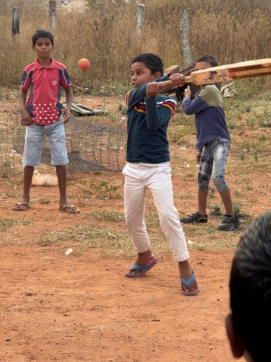 A boy batting during evening cricket at the home